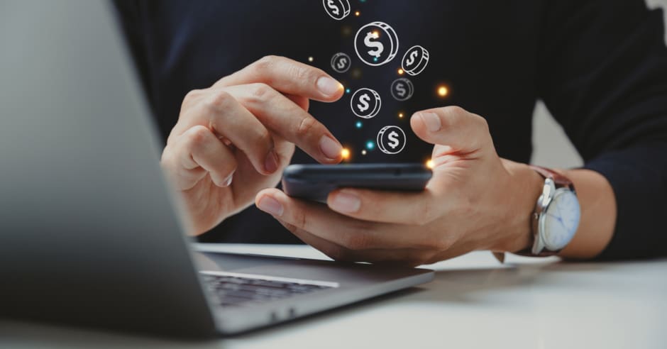 Hand of a businessman using a smartphone for payment, which is one of the newest commercial real estate technology trends