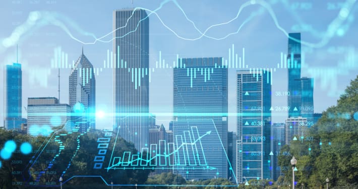Financial district skyline with a hologram graph overtop illustrating a commercial real estate transaction